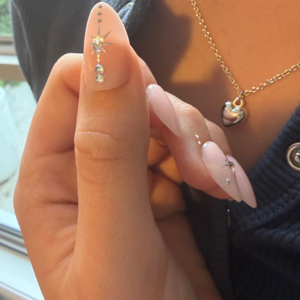 Australian woman applying Sugar Tips press-on nails at home