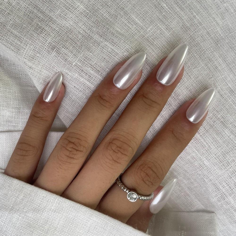 Hand lying flat wearing Sugar Tips Glass Slipper Pearl Chrome Glazed Donut Almond Press On Nails.