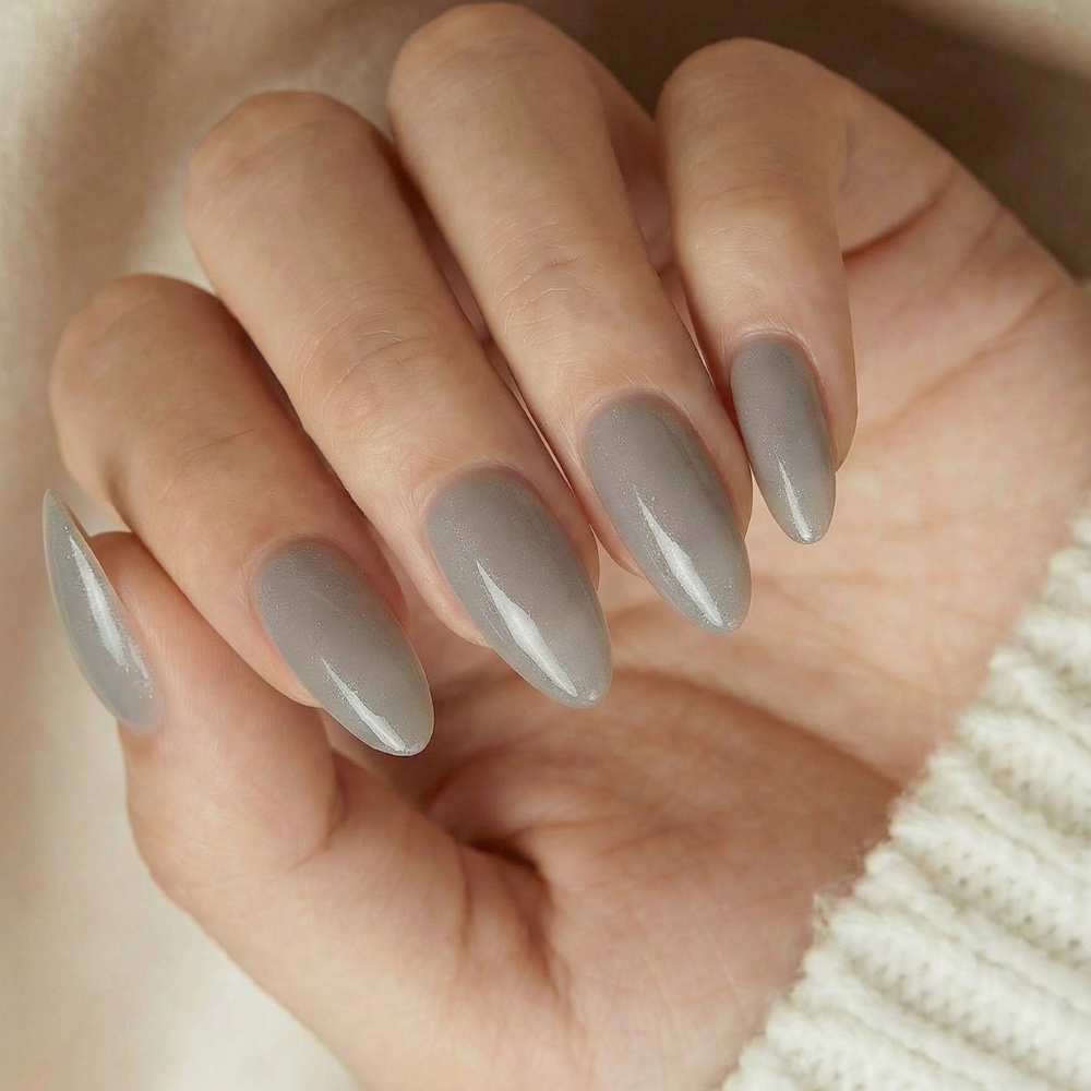 Hand with gray press on nails on a neutral background