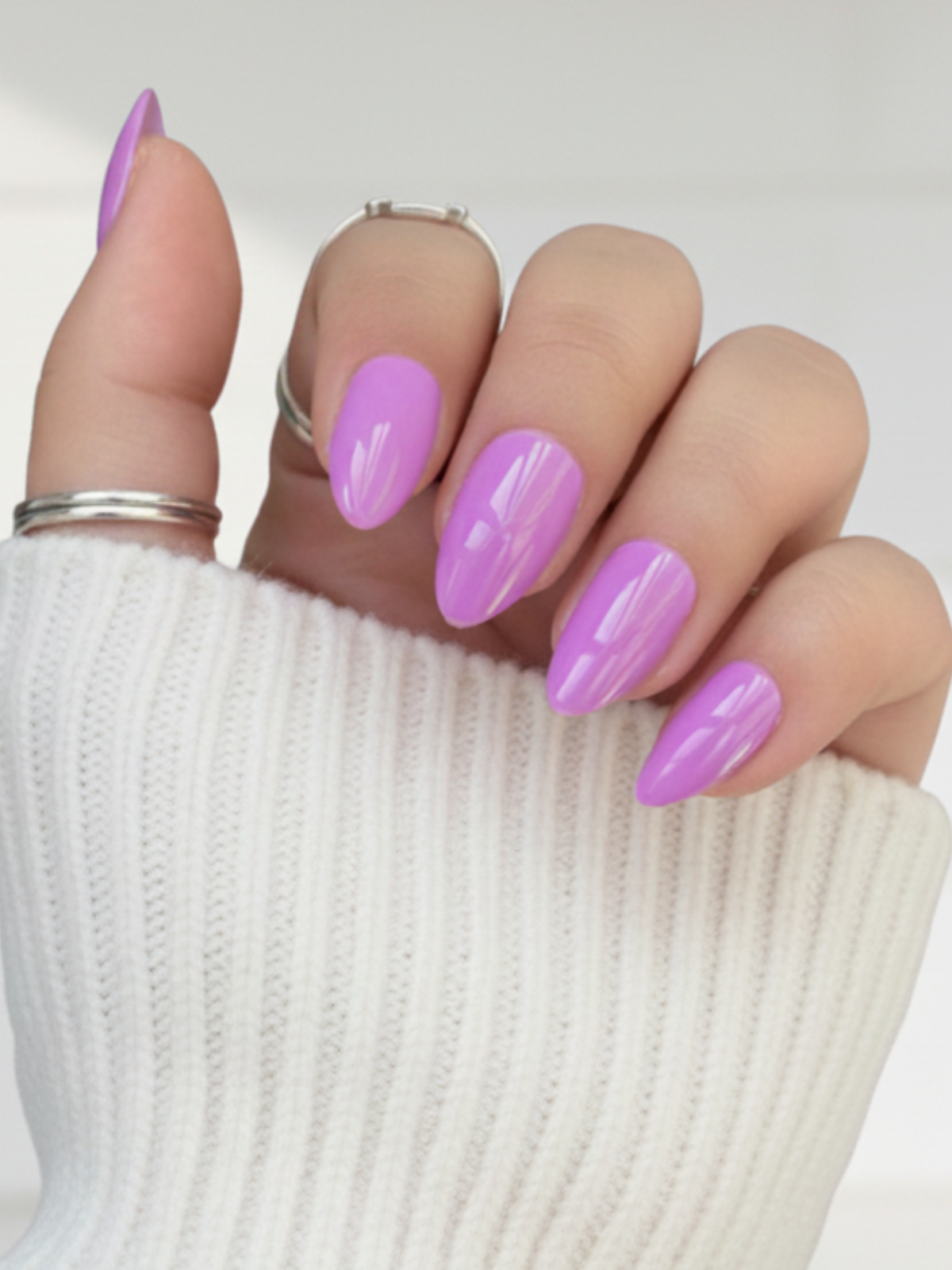 Hand showcasing bright purple press on nails