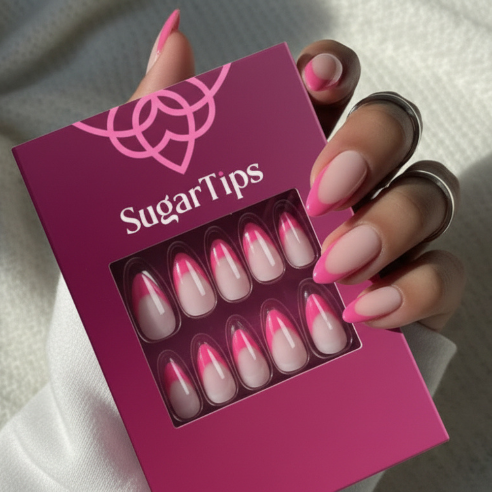 A hand holding a box of Sugar Tips press on nails